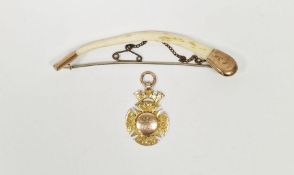 9ct gold-mounted bone brooch and a 9ct gold fob pendant dated 1921, inscribed 'EH Stent' and 'U.P.
