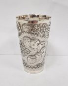Foreign silver-coloured metal cup with relief of village and figures, initialled to base 'D.M.D',