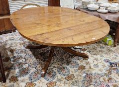 Oak single pedestal extending dining table by Richard Wood with oval top and on heavy baluster