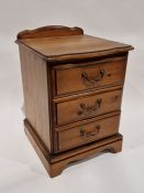 20th century pine bedside chest of drawers comprising three drawers, each with metal loop handles,