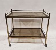 20th century brass two-tier drinks trolley with glass panels, raised on original castors, 65cm