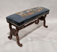 Victorian mahogany footstool of oblong form, the blue upholstered top with needlework decoration