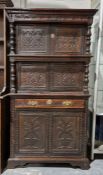 17th century-style carved oak narrow court cupboard, the top section having two two-door cupboards