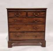 George III mahogany chest of drawers having a retractable brushing slide to the top, over two