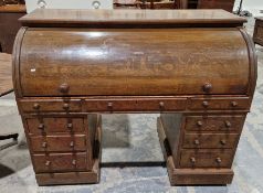 Early 20th century oak rolltop desk, the roll top opening to reveal a line of five drawers, each
