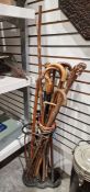 Quantity of walking sticks, riding crop and umbrella in iron stickstand