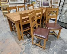 Contemporary oak extending dining table of rectangular form, raised on square legs, 79cm high x