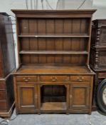 19th century stained wooden kitchen dresser, the top section having two fitted plate racks, the