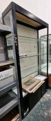 Large glazed display cabinet with three adjustable glass shelves, raised over a two-door sliding