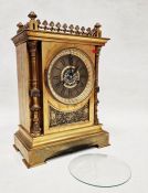 Moulded brass mantel clock of rectangular form with Gothic revival decoration, the dial with