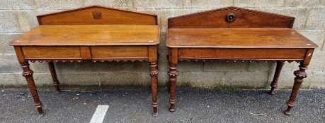 Matched pair of 19th century oak hall tables, each with ornate flowing frieze, one having two