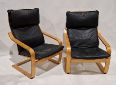 Pair of modern Ikea armchairs, each with black leatherette-style upholstery, on wooden frames,