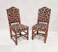 Set of four reproduction oak dining chairs, each with broken arched padded back and seat, in