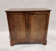 19th century mahogany two-door cupboard, the doors opening to reveal two removable shelves, with