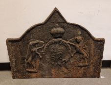Cast iron fireback with indistinct armorial crest, possibly a royal coat of arms, broken arch top