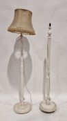 Two white painted standard lamps, raised on circular pedestal bases, one having a lampshade, largest