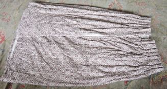 Pair of pinch pleat curtains, each printed in deep purple with flowerhead and geometric patterns,