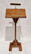 20th century oak lectern on stand with fitted brass light to top, 136cm high excluding light fitting