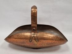 Arts & Crafts-style hammered copper trug with bar and strapwork handle, curved body
