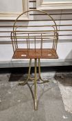 Early 20th century oak and brass periodical stand, raised on three splayed legs, 79cm high