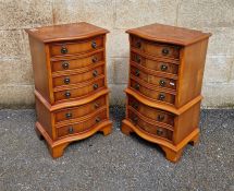 Pair of reproduction burrwood bedside cabinet chests of serpentine form, each comprising six