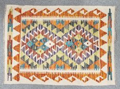 Cream ground Chobi kilim with two central stepped geometric medallions, single geometric borders ,