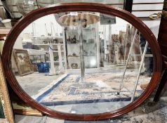20th century mahogany framed wall mirror of oval form, 91cm x 73cm