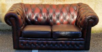 20th century leatherette upholstered Chesterfield two-seat sofa raised on castors, 162cm long