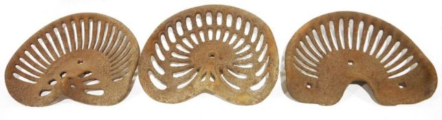Three vintage cast iron tractor seats, one marked 'Walter A Wood' (3)