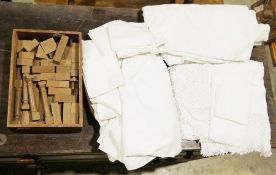 Box of vintage wooden building blocks and a quantity of white linen