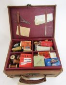 Canvas and leather carrying case containing various fishing accessories including salmon scales,