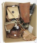 Three canvas and leather gun carrying slings, a small cartridge case, a sleeve with suede pad for