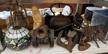 Tiffany-style lightshade, a vintage storm lamp, a wooden model of a cannon, two cast iron cobblers