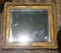 Two 20th century wall mirrors, the first of oval form with reeded dark stained wooden frame, 67cm