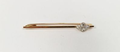 1920's/1930's gold-coloured metal and diamond bar brooch, having four diamonds in rubover setting