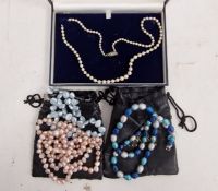 Graduated cultured pearl necklace and three strings of modern pearls to include pink and blue