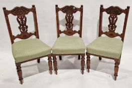 Set of three early 20th century oak dining chairs with pierced and carved splat backs and