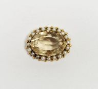 Gold coloured metal seedpearl and citrine brooch set over central oval cut citrene coloured stone