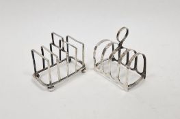 Two silver toast racks, the first with ball feet, hallmarked Sheffield 1912, maker's marks for