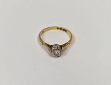 18ct gold and platinum solitaire diamond ring, the diamond illusion set with foliate shoulders (