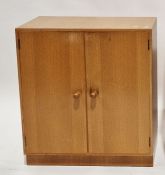 Modern two-door oak cupboard by Meredew, the doors opening to reveal two adjustable shelves with