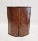 Late 19th century oak corner cupboard, 2 door, bow fronted, integral shelves replaced by laminated