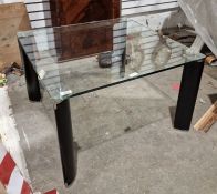 Modern glass-topped coffee table of square form raised upon black and chrome legs, 41cm high x