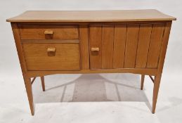 Mid century polished wood sideboard with bevelled top above cupboard and two drawers, raised on