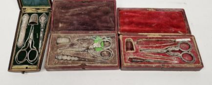 Three 19th century cased part etui sets, two in leather boxes, the other wooden, containing silver