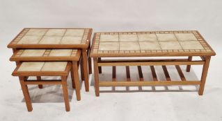 Nest of three 20thC tiled-top side tables of rectangular form, 57cm wide approx. together with a