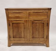Modern oak cabinet with two fitted drawers above two door cupboard, the handles are moulded to fit