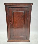 19th century oak corner cupboard, the single door opening to reveal two fitted shelves, 125cm high x