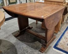 Oak drop-leaf dining table on standard end supports