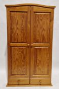 Modern pine two door wardrobe, above two short drawers, measuring approximately 176cm high x 101cm